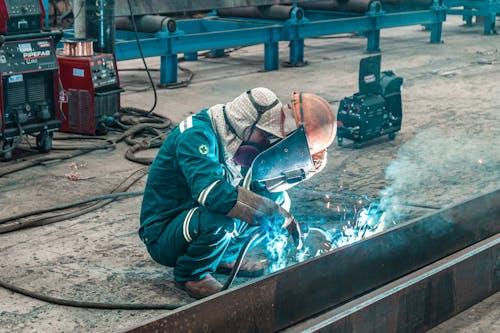 A Man Welding in the Workshop 