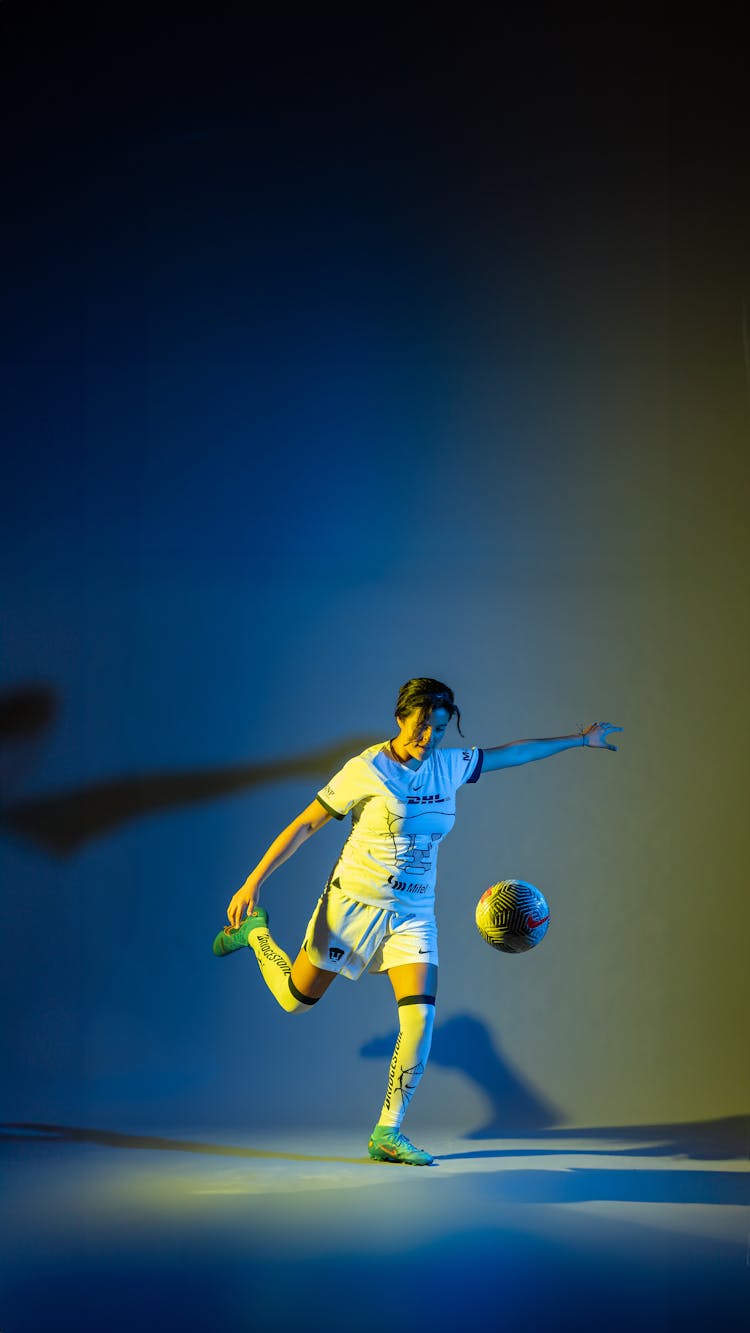 A Soccer Player Kicking The Ball 