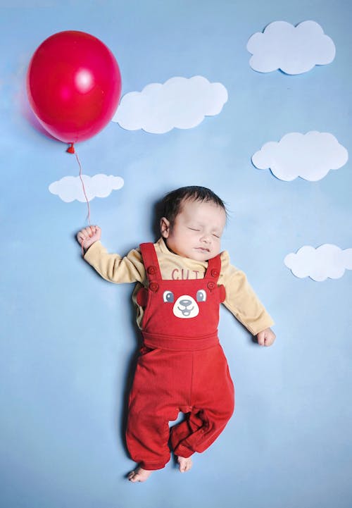 Baby Sleeping with Red Balloon and Clouds