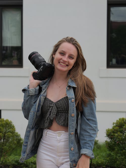 Smiling Woman in Jean Jacket and with Camera