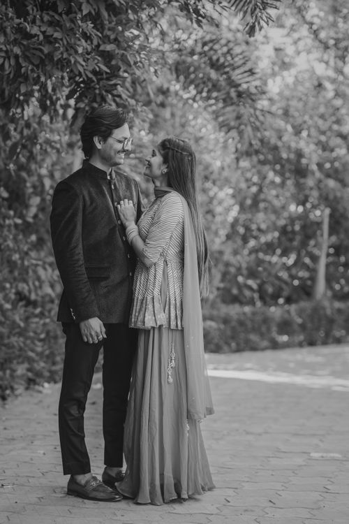 Free A joyful Indian newlywed couple standing together in traditional attire, outdoors. Stock Photo