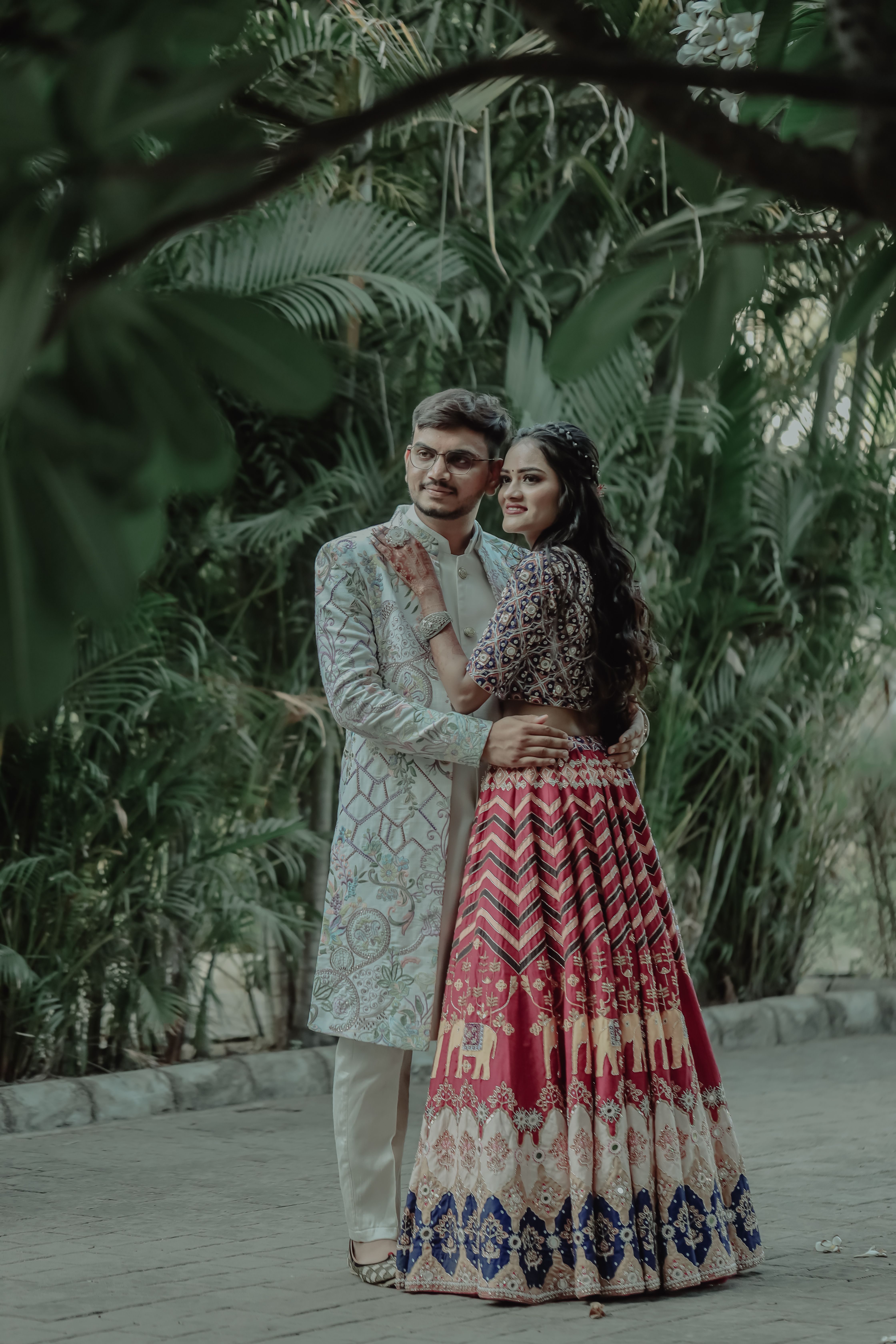 A charming Indian couple embracing in traditional clothing for a wedding photoshoot.