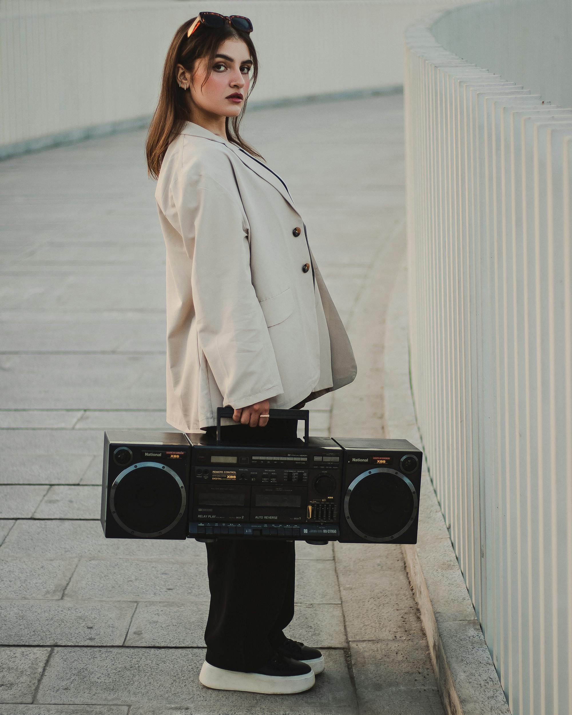 woman in coat posing with radio