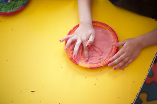 Kindergarten student playing with dirt