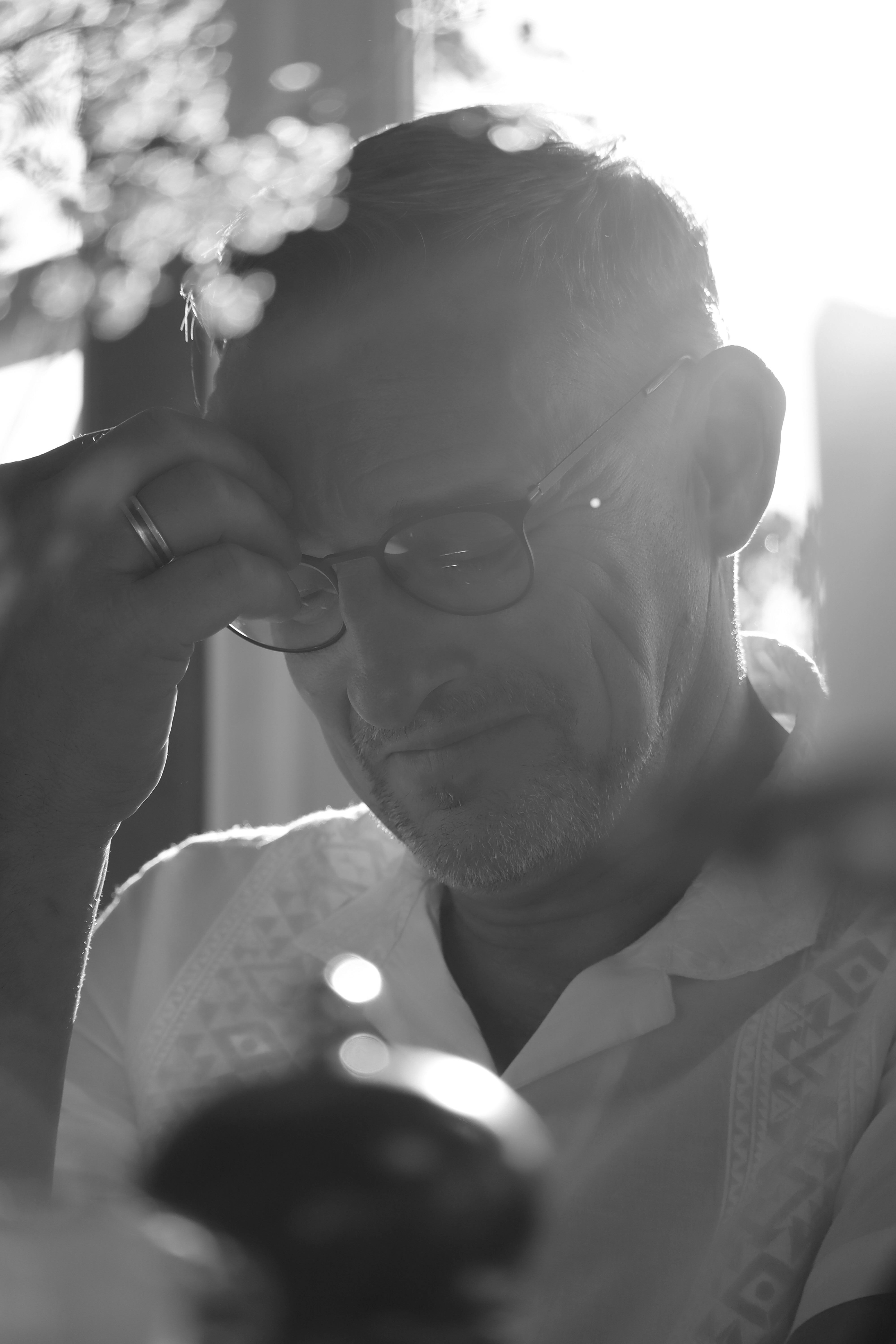 Thoughtful black and white portrait of a mature man in reflective pose.