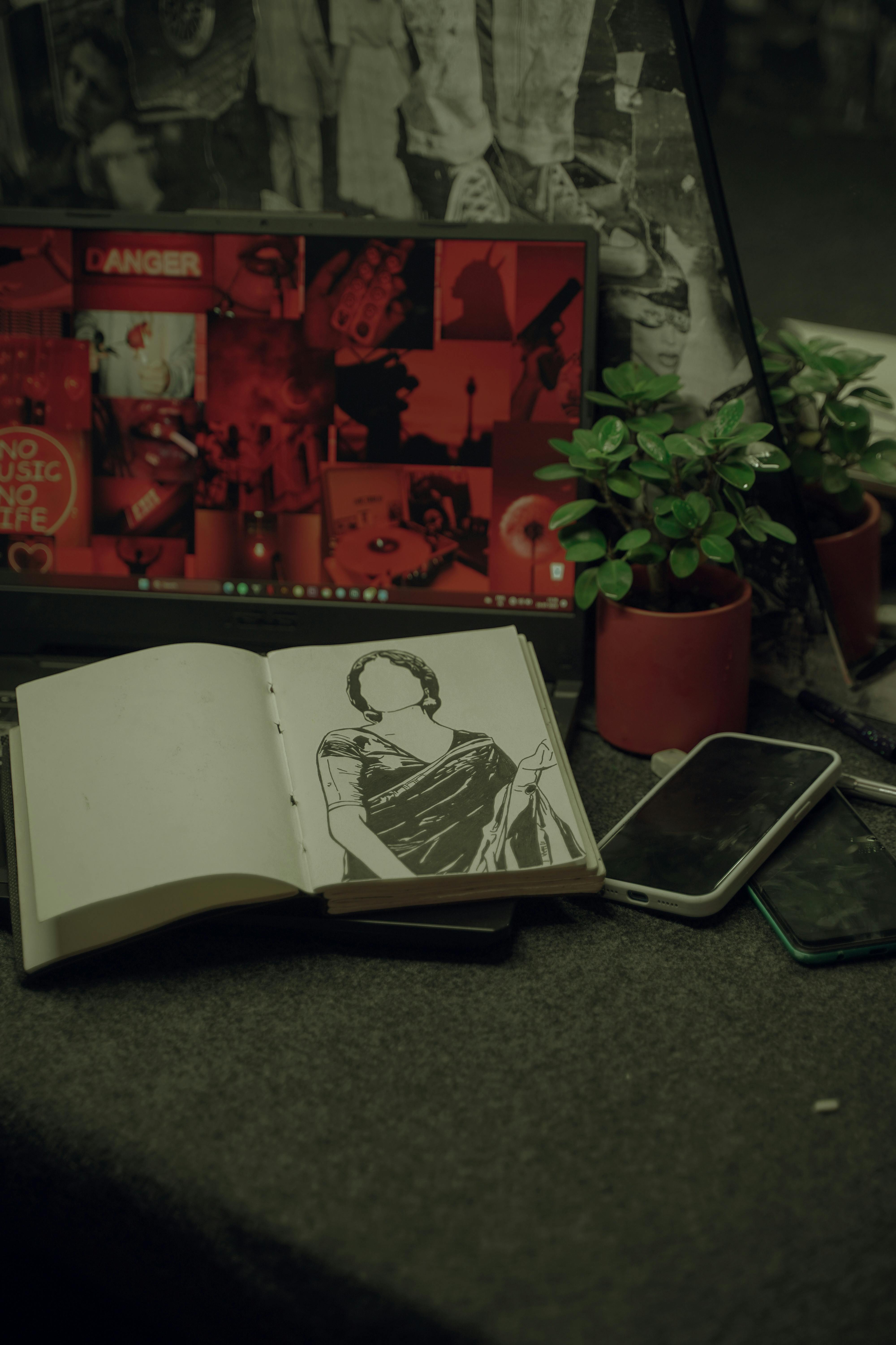 a book a phone and a plant on a table