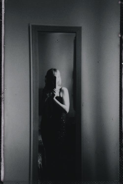 Woman Taking Pictures in Mirror in Black and White