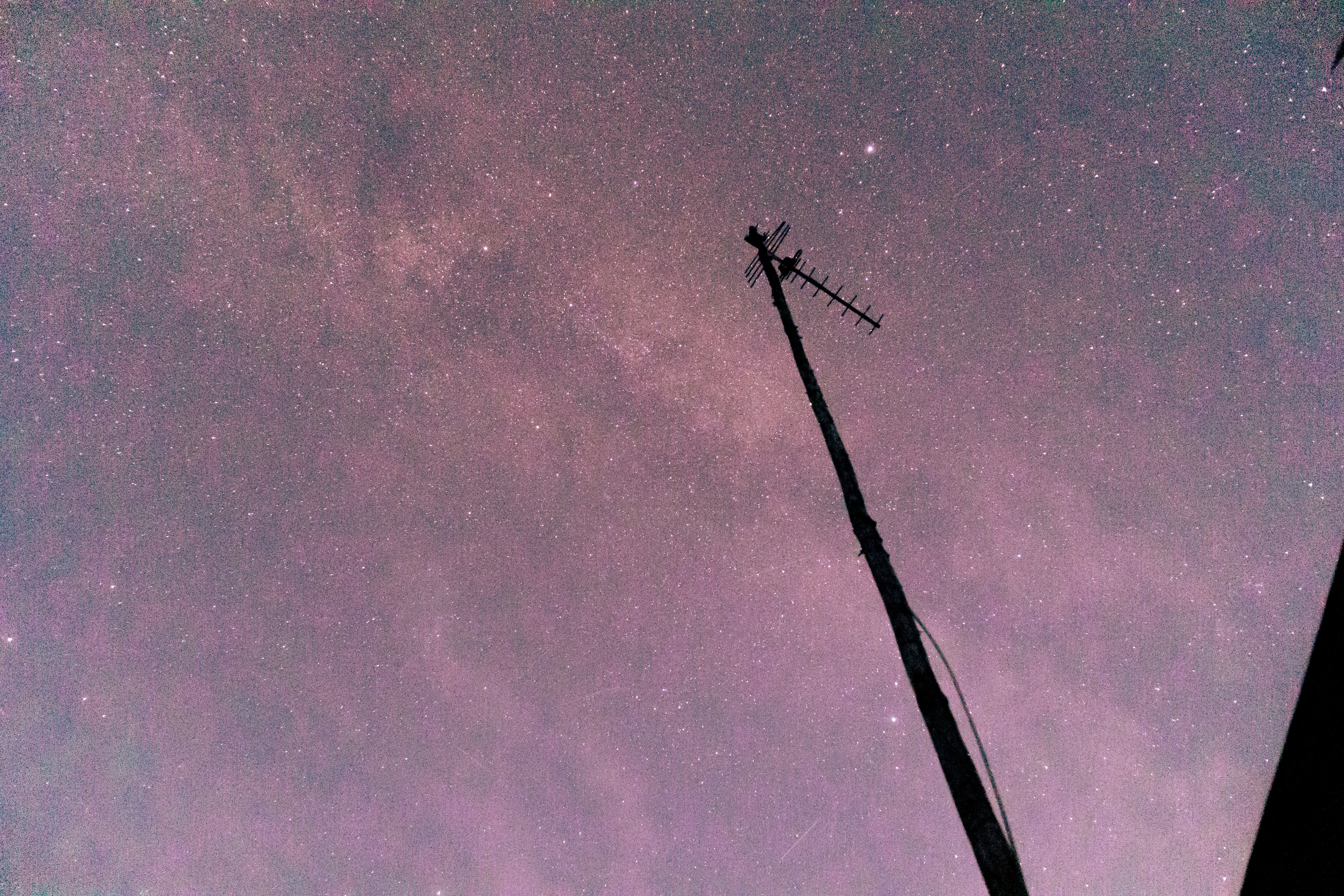 A star-filled night sky with a silhouetted antenna, showcasing the beauty of astronomy.