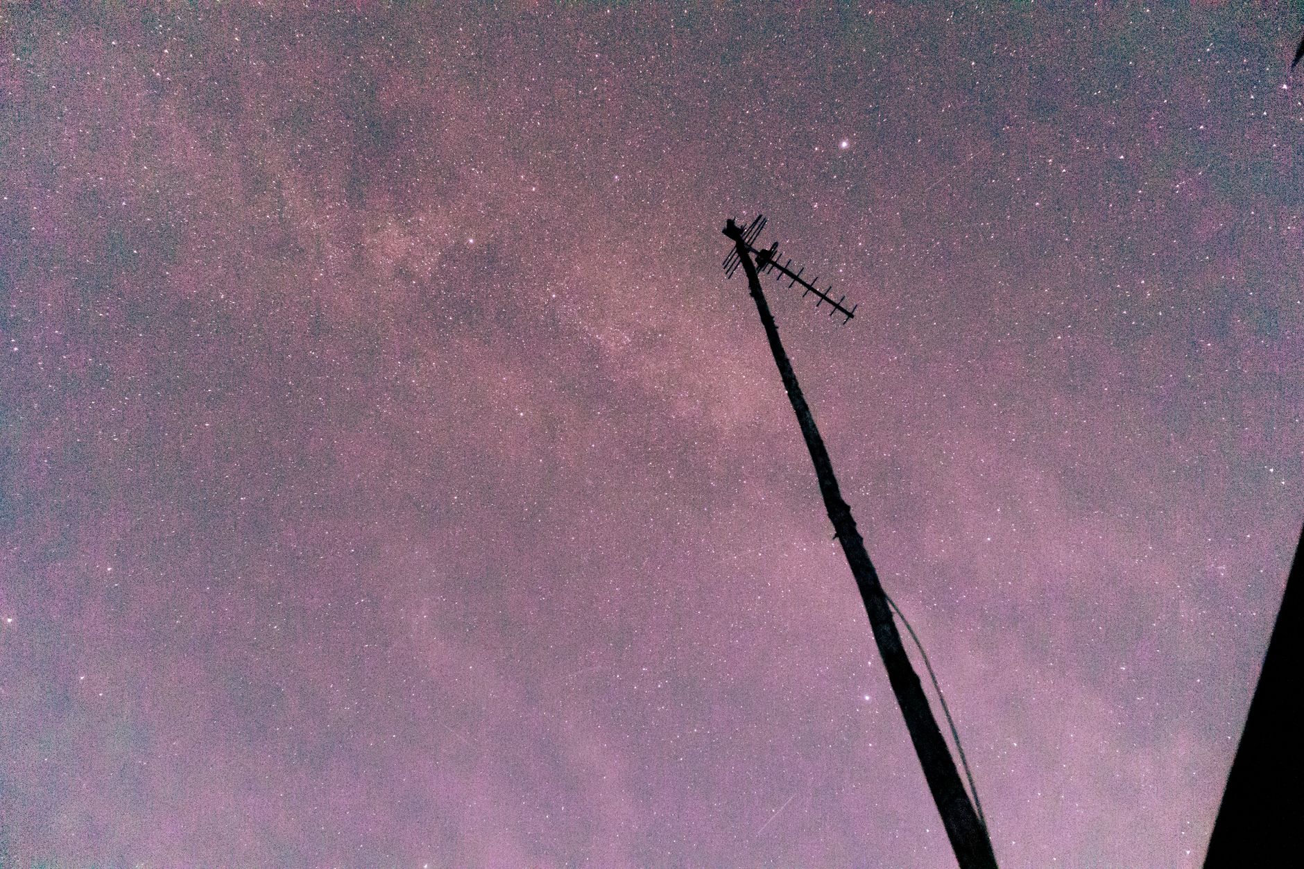 A star-filled night sky with a silhouetted antenna, showcasing the beauty of astronomy.