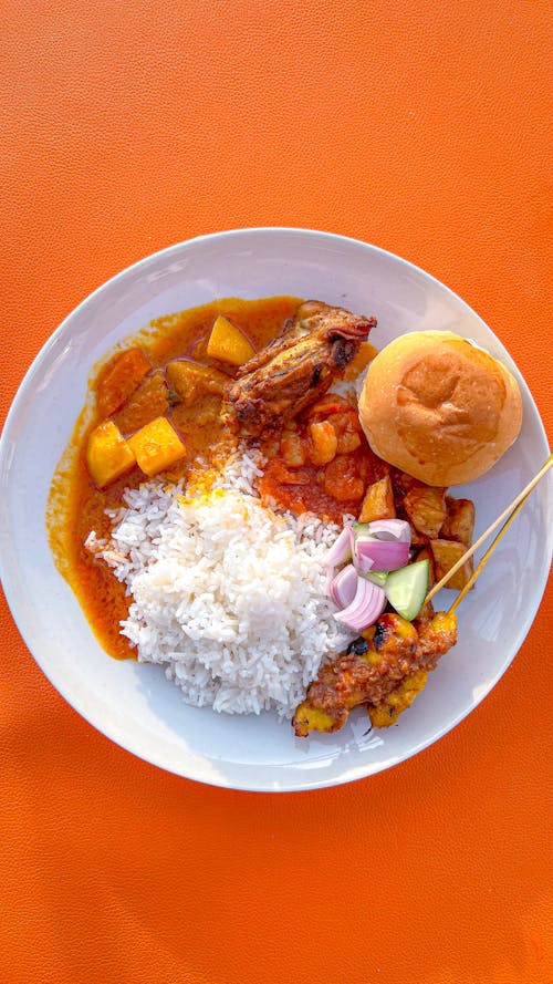 Fried Chicken with Rice and Sauce on Plate