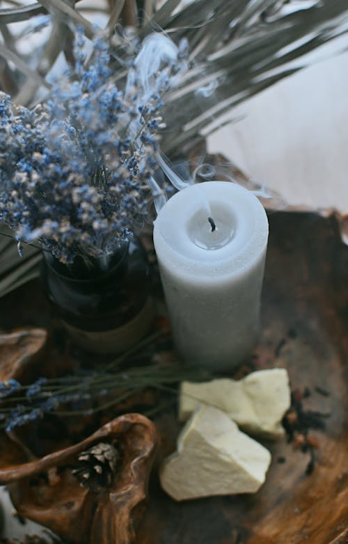 Burnt Wax Candle near Flowers