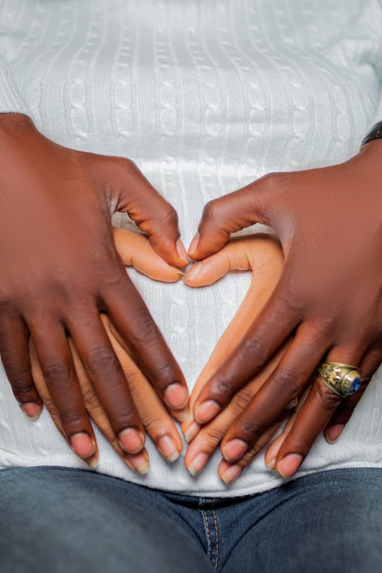 Man Hands On Woman Hands On Stomach