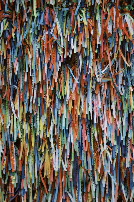 Colorful Brazilian wish bracelets hanging in abundance as lucky charms.