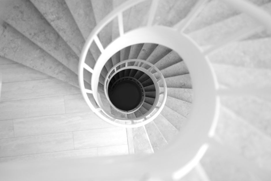 Top view of a black and white spiral staircase with elegant curves and architectural beauty.