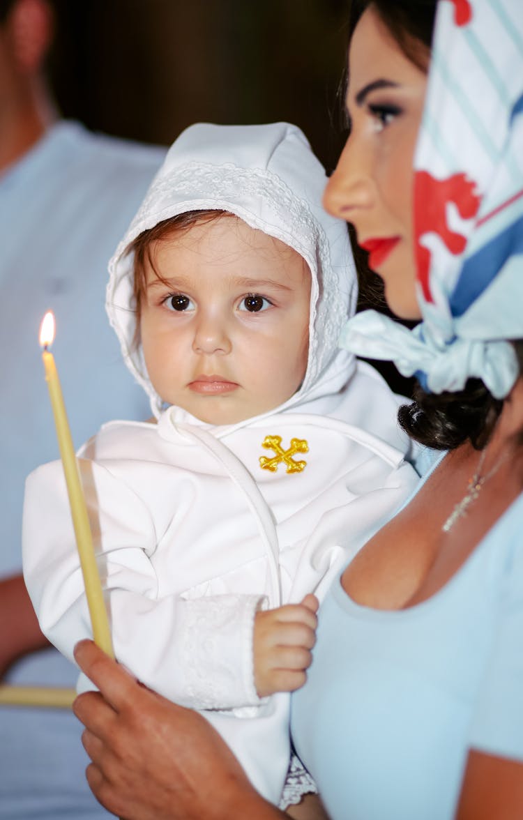 Woman Holding A Baby And A Candlestick 