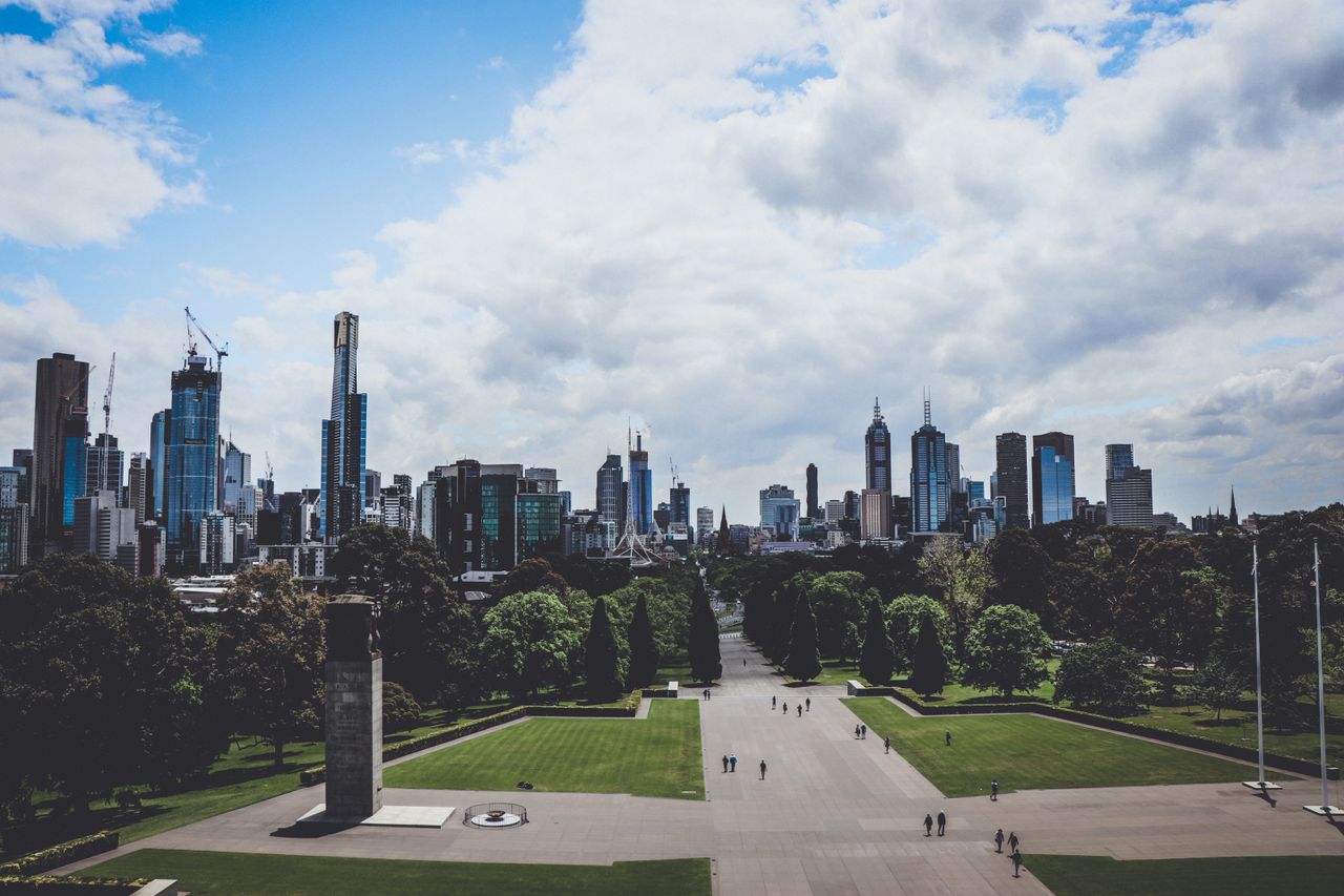 stunning view of melbourne skyline viewed from a park showcasing skysc