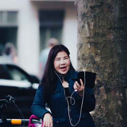 Woman Talking on Smartphone with Earphones
