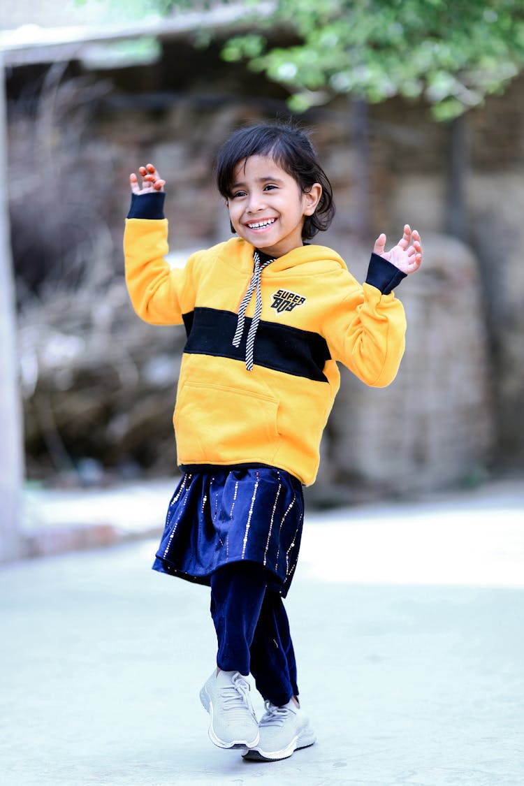 Smiling Kid Dancing On Street