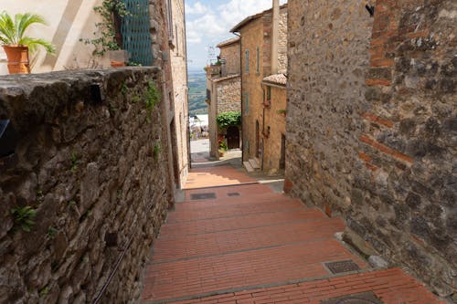 A Narrow Alley with Steps between Historical Stone Buildings 