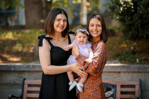 Smiling Women Posing with Baby