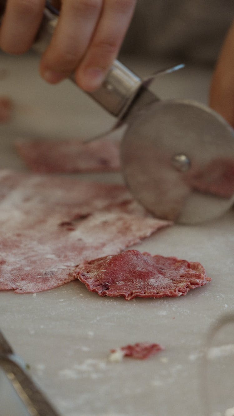 A Person Cutting Meat