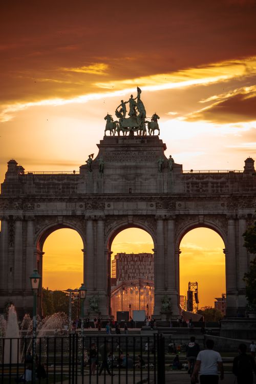 Free A breathtaking view of the Cinquantenaire Arch in Brussels at sunset, featuring vibrant skies and architectural beauty. Stock Photo