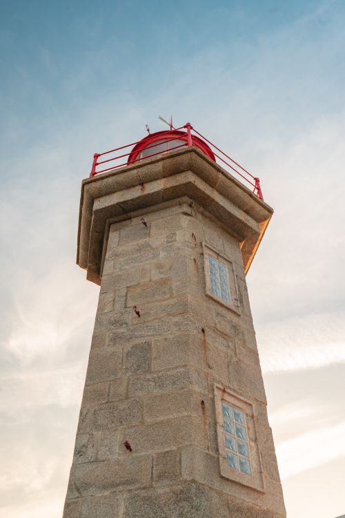 Free Stunning view of the Farolim de Felgueiras lighthouse against a clear summer sky in Porto, Portugal. Stock Photo