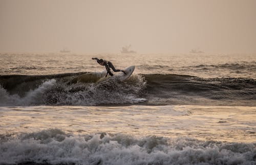 Surfer on Ocean Wave at Dawn