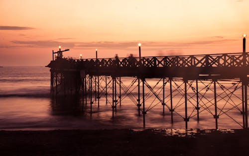 Pier on Ocean Shore at Dusk