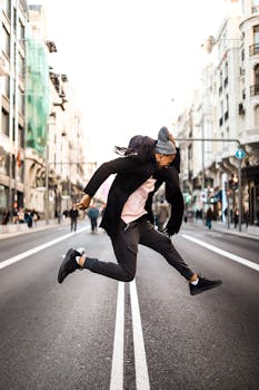 Stylish man in black jacket jumping on a vibrant Madrid street.