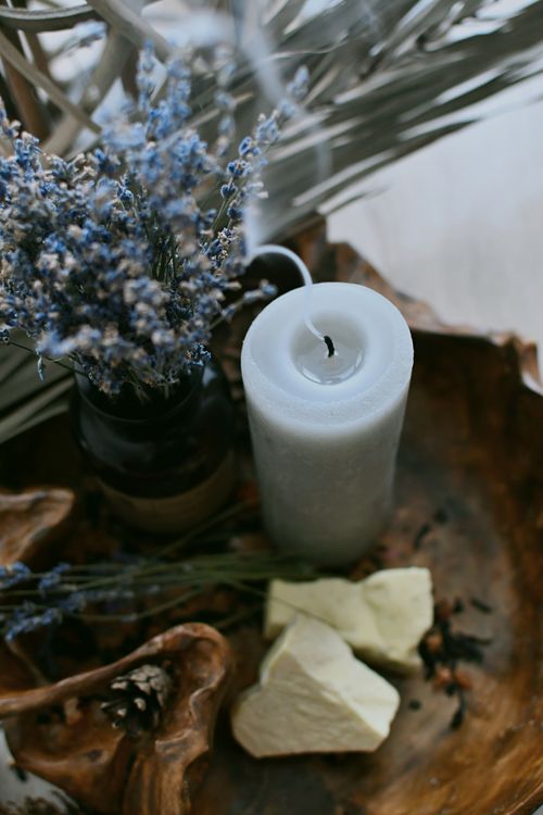 Free A calming still life featuring a candle, dried flowers, and natural decor elements. Stock Photo