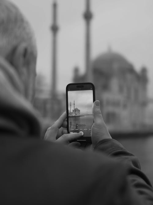 Elderly Man Taking Photo of Mosque with Phone