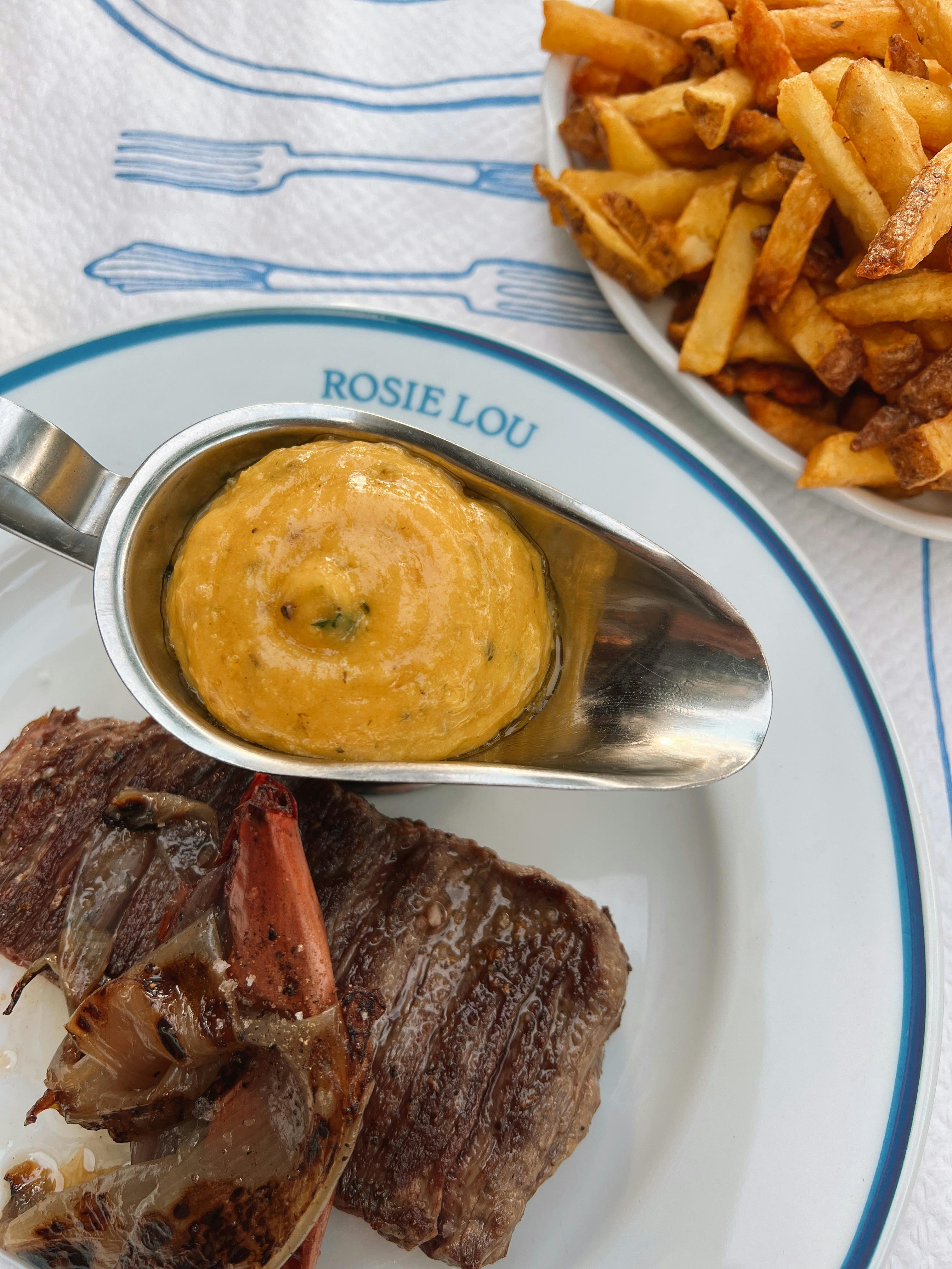 Free Top view of a steak and fries with a savory sauce, perfect for foodie inspiration. Stock Photo