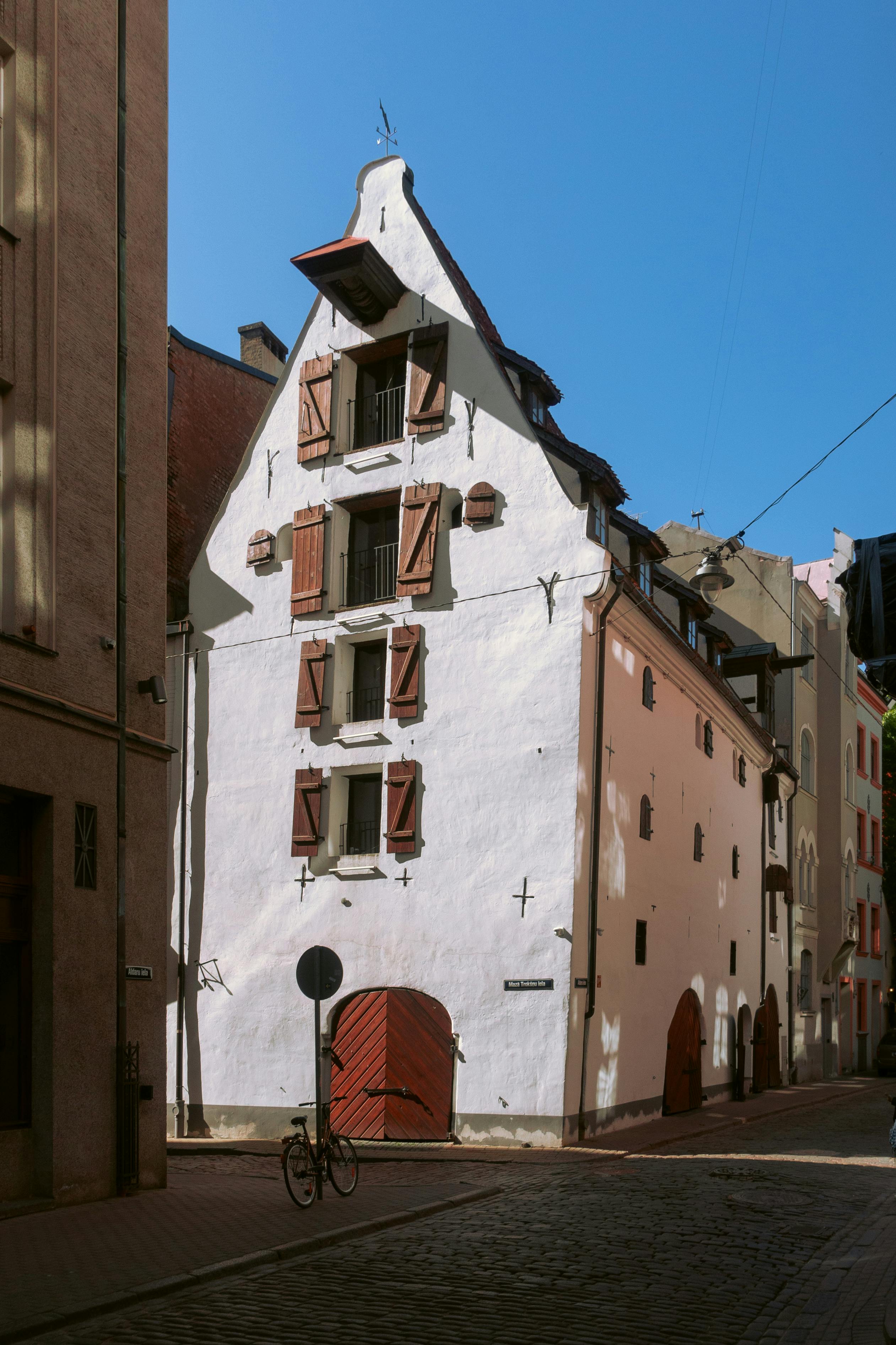 Charming historic building with unique architecture in Old Riga, highlighted under clear blue skies.