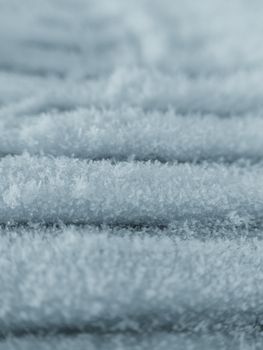 Explore the intricate frost patterns on a winter surface, showcasing icy layers.