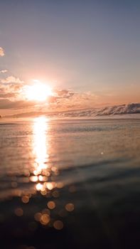A breathtaking view of a sunset reflecting over gentle ocean waves, creating a serene evening mood.