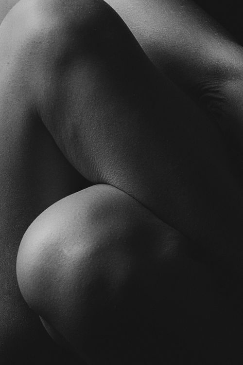 Free Black and white close-up of a human form emphasizing texture and light contrast. Stock Photo