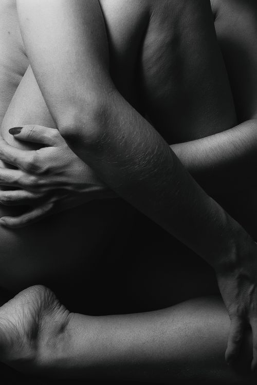 Free Close-up artistic black and white nude embrace, focusing on intertwined arms and legs. Stock Photo
