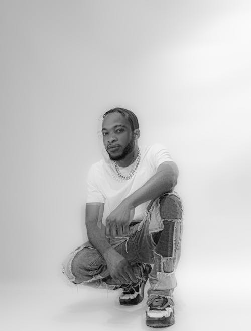 Portrait of a Male Model Wearing a T-Shirt and Patchwork Pants