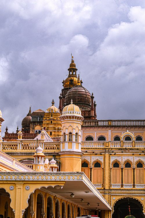 Free Detailed architectural shot of the iconic Mysore Palace in Mysore, India, under a cloudy sky. Stock Photo