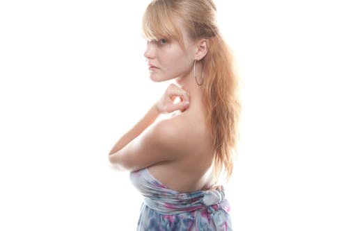 Portrait of a Pretty Blonde Posing against a White Background