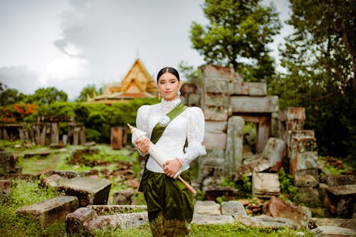 Woman in Elegant Traditional Costume against Ruins of Angkor Wat
