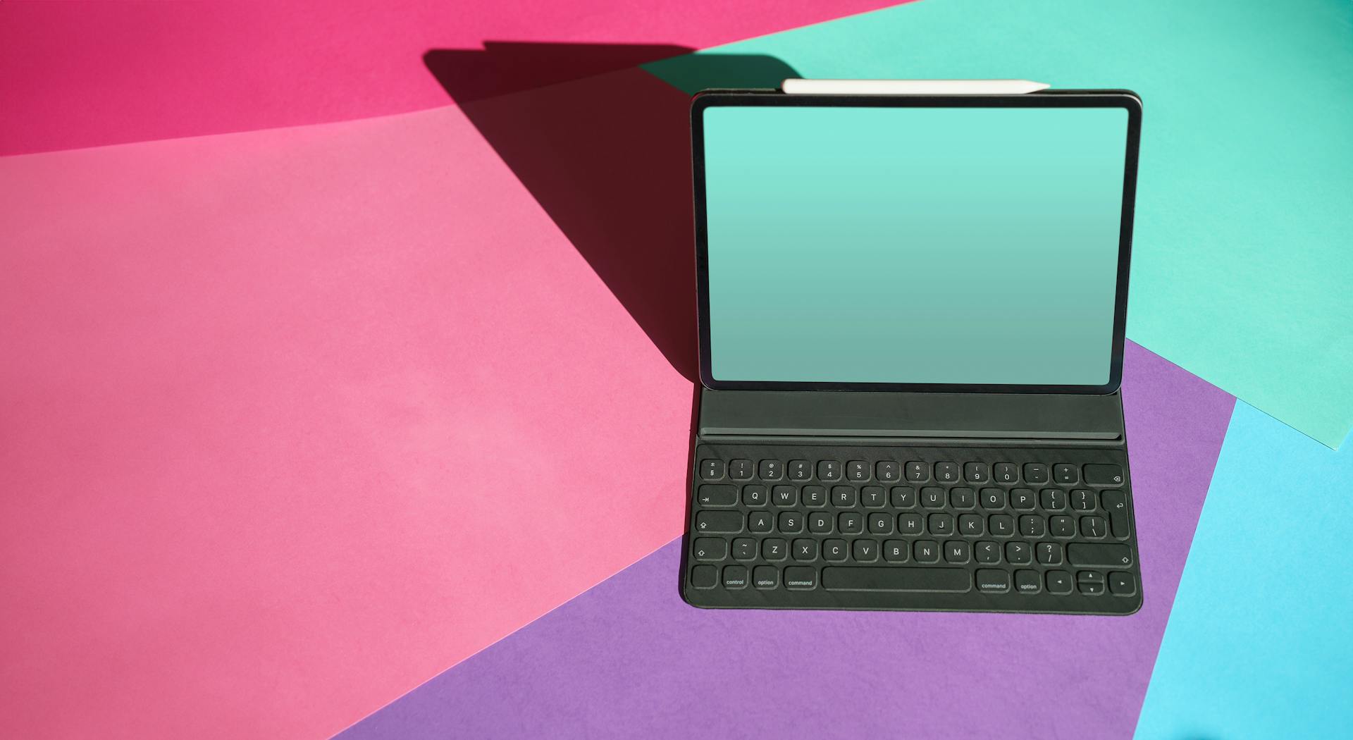 A modern tablet with a keyboard on a vibrant, colorful background perfect for tech and design themes.