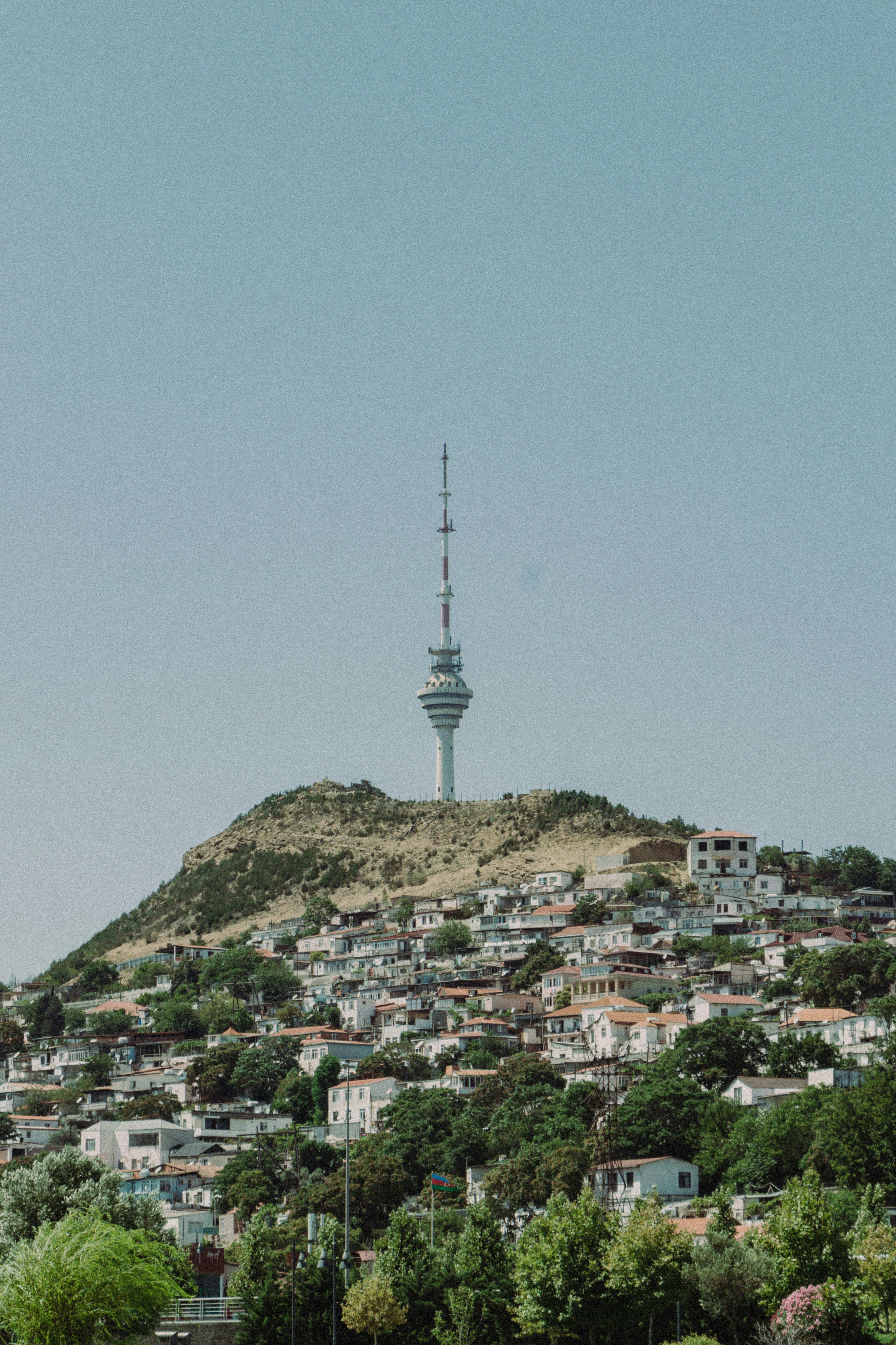 Scenic view of Baku with TV tower standing on a hill against a clear sky.