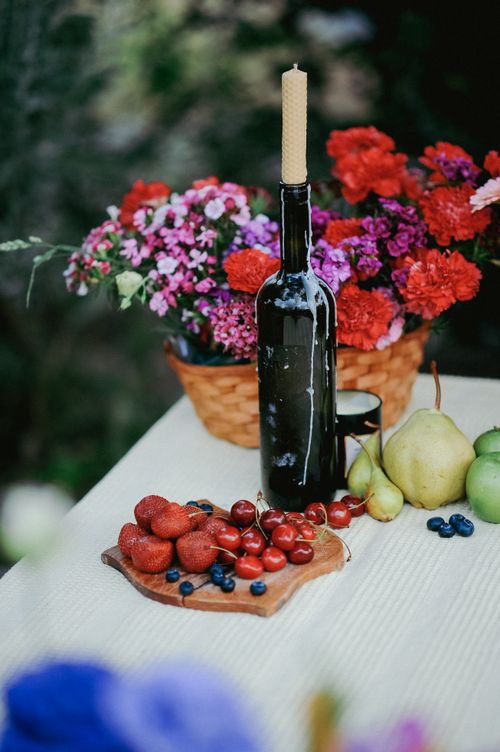 Free Vibrant summer outdoor table with flowers, fruits, and a candlestick. Stock Photo
