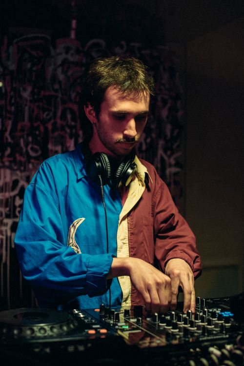 Free A DJ wearing headphones works with a sound mixer at an indoor venue in Lviv, Ukraine. Stock Photo