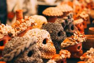 Vibrant artisan skulls on display at a market in Oaxaca, Mexico, perfect for festive decor.