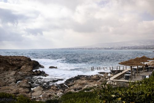 Free Peaceful coastal scene with rocky shorelines and ocean waves. Stock Photo