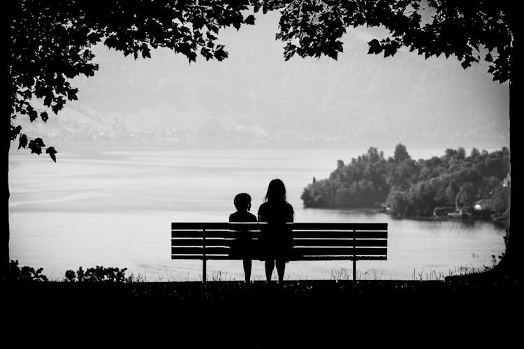 Woman Sitting On A Bench With A Child