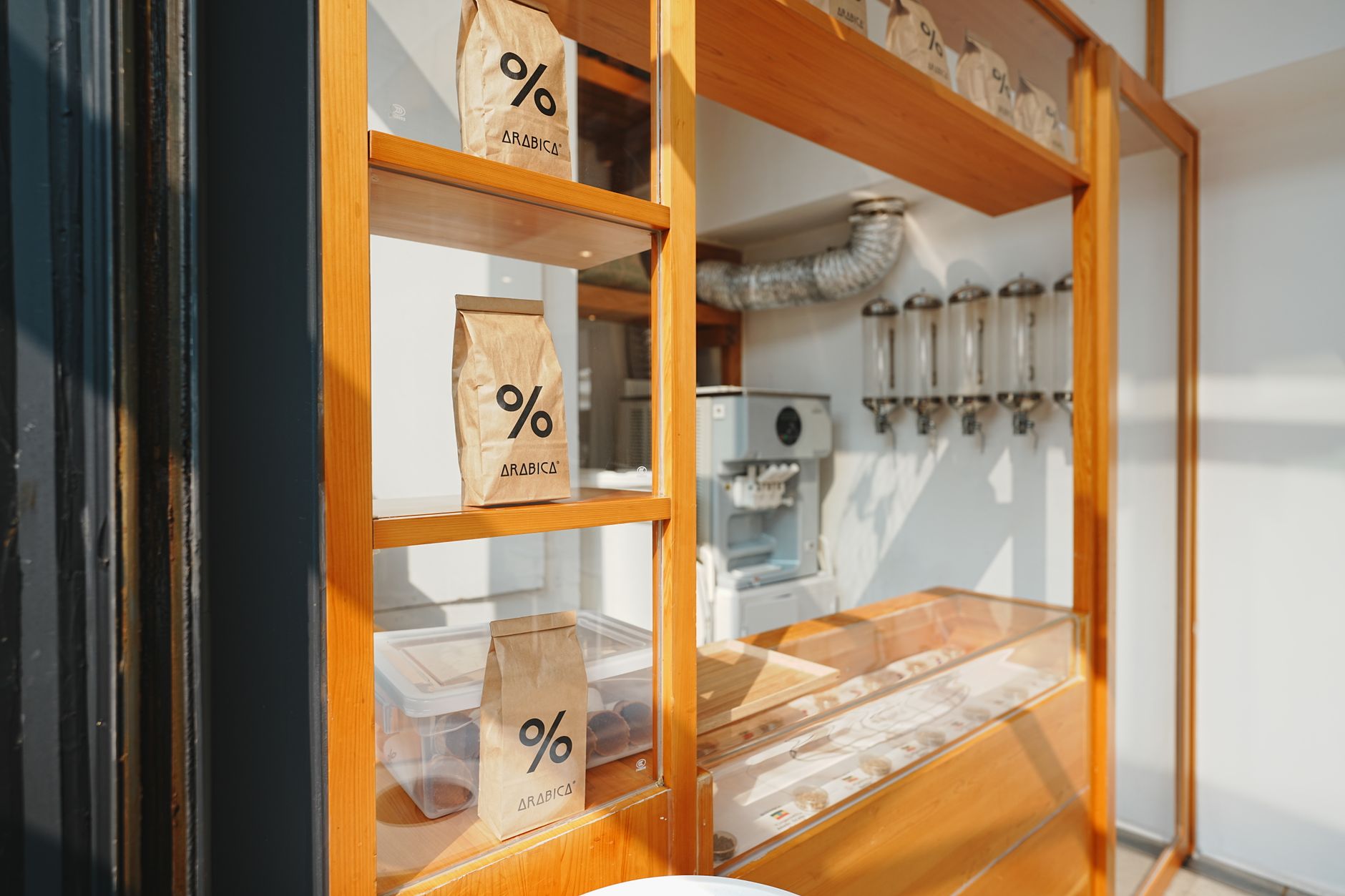 Showcasing premium Arabica coffee bags in a sleek, sunlit retail setting.